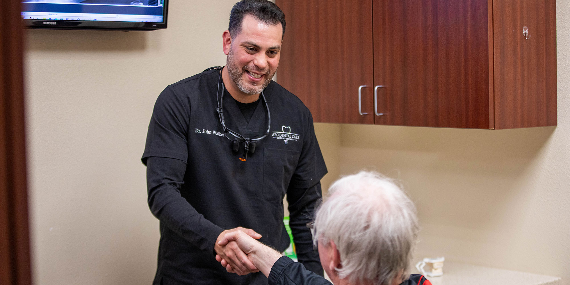john walker,dds shaking patients hand